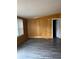 Living room with wood paneling and gray vinyl flooring at 3600 Grady Smith Rd, Loganville, GA 30052