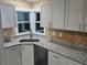 Kitchen with granite countertops and white cabinets at 3600 Grady Smith Rd, Loganville, GA 30052