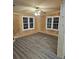 Living room featuring gray vinyl flooring and two large windows at 3600 Grady Smith Rd, Loganville, GA 30052