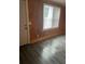 Living room featuring wood paneling and gray flooring at 3600 Grady Smith Rd, Loganville, GA 30052
