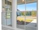 View of the home's exterior from the front, showcasing a white door and lake view at 6051 Stallion Rdg, Douglasville, GA 30135