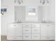 Double vanity bathroom with white cabinets and a large mirror at 6051 Stallion Rdg, Douglasville, GA 30135