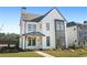 Two-story white farmhouse with gray accents and a metal roof at 6051 Stallion Rdg, Douglasville, GA 30135