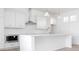 Modern white kitchen with island, stainless steel appliances, and white cabinetry at 6051 Stallion Rdg, Douglasville, GA 30135