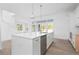 Kitchen island with sink, dishwasher, and view into Gathering room at 6051 Stallion Rdg, Douglasville, GA 30135