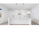 Modern white kitchen with large island and stainless steel appliances at 6051 Stallion Rdg, Douglasville, GA 30135