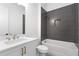 Bathroom with white vanity and grey tile tub surround at 6051 Stallion Rdg, Douglasville, GA 30135