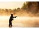 Person fly fishing in a calm river at sunrise at 6051 Stallion Rdg, Douglasville, GA 30135