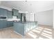 Modern kitchen with light green cabinets and a large island at 6001 Stallion Rdg, Douglasville, GA 30135