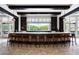 Long marble-topped bar with wooden barstools, large windows to outside at 6001 Stallion Rdg, Douglasville, GA 30135