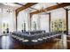 U-shaped meeting table with chairs in a large room with high ceilings and natural light at 6001 Stallion Rdg, Douglasville, GA 30135