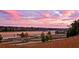 Stunning sunset over rolling hills and pastures at 6001 Stallion Rdg, Douglasville, GA 30135