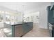 Modern kitchen with a large island, stainless steel appliances, and light green cabinetry at 6001 Stallion Rdg, Douglasville, GA 30135