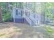Inviting blue house nestled amongst lush green trees, a walkway leads to the entrance at 2836 Harlan Dr, Atlanta, GA 30344