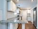 Modern kitchen with granite countertops, white cabinets, and hexagon tile backsplash at 2836 Harlan Dr, Atlanta, GA 30344