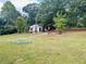 Small white cottage style home with green lawn at 35 Clayton Path, Douglasville, GA 30134