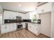 White kitchen with stainless steel appliances and black hexagon tile backsplash at 3152 Spreading Oak Sw Dr, Atlanta, GA 30311