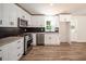 Modern kitchen with white cabinets, black backsplash, and stainless steel appliances at 3152 Spreading Oak Sw Dr, Atlanta, GA 30311