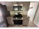 Stainless steel gas range and microwave in updated kitchen at 435 Ridgedale Way, Lawrenceville, GA 30044