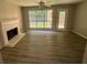 Living room with fireplace, vinyl flooring, and access to backyard at 435 Ridgedale Way, Lawrenceville, GA 30044