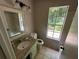 Updated bathroom with granite countertop and a window at 435 Ridgedale Way, Lawrenceville, GA 30044