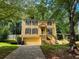 Two-story yellow house with a large yard and attached garage at 435 Ridgedale Way, Lawrenceville, GA 30044