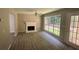 Living room with fireplace, vinyl flooring, and sliding glass doors at 435 Ridgedale Way, Lawrenceville, GA 30044