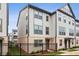 Modern 3-story townhome with gray siding and brick accents at 2632 Caruso Way, Atlanta, GA 30339