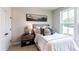 Bright bedroom with queen bed, nightstand, and large window with view at 738 Crossroad Ct, Powder Springs, GA 30127