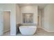 Modern bathroom with soaking tub and walk-in shower at 201 Haverling Pass, Hampton, GA 30252