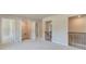 Upstairs laundry room with carpeting and adjacent bedrooms at 201 Haverling Pass, Hampton, GA 30252