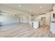 Open floor plan connecting Gathering room and kitchen areas with hardwood floors at 201 Haverling Pass, Hampton, GA 30252
