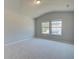 Bedroom with vaulted ceiling, neutral carpeting, and window views at 201 Haverling Pass, Hampton, GA 30252