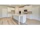 Modern kitchen with white cabinets, large island, and stainless steel appliances at 201 Haverling Pass, Hampton, GA 30252