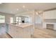 Open concept kitchen with island, stainless steel appliances, and view of Gathering room at 201 Haverling Pass, Hampton, GA 30252