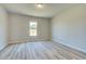 Spacious bedroom with large window and wood-look flooring at 201 Haverling Pass, Hampton, GA 30252
