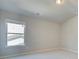 Bright bedroom with vaulted ceiling, neutral carpeting, and a window at 201 Haverling Pass, Hampton, GA 30252