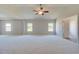 Main bedroom with vaulted ceiling, ceiling fan, neutral carpeting and multiple windows at 201 Haverling Pass, Hampton, GA 30252