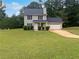 Two-story house with gray siding, landscaping, and a two-car garage at 9105 Sterling Lakes Cir, Covington, GA 30014