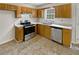 Kitchen with wood cabinets, stainless steel appliances, and tiled floor at 9105 Sterling Lakes Cir, Covington, GA 30014