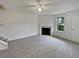 Bright living room with a fireplace and neutral carpeting at 9105 Sterling Lakes Cir, Covington, GA 30014