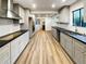 Modern kitchen with gray cabinets and a large island at 3624 Nessa Se Ct, Smyrna, GA 30082