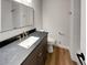 Updated bathroom with dark vanity, modern fixtures, and white tile shower at 3624 Nessa Se Ct, Smyrna, GA 30082
