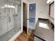 Modern bathroom with a frameless shower and dark vanity at 3624 Nessa Se Ct, Smyrna, GA 30082