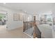 Upstairs hallway with neutral carpeting, black railing, and access to bedrooms at 404 Beacon Way, Villa Rica, GA 30180