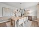 Elegant dining room with a long wooden table, modern light fixture, and stylish decor at 404 Beacon Way, Villa Rica, GA 30180