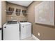 Laundry room with washer, dryer, and overhead shelving at 404 Beacon Way, Villa Rica, GA 30180