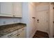 Bright foyer with granite countertop and white cabinets at 110 Mountain Laurel Ct, Canton, GA 30114