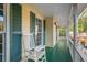 Inviting front porch with rocking chair and green floor at 1486 Willow Bnd, Woodstock, GA 30188