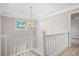 Elegant staircase with white railings and chandelier at 1486 Willow Bnd, Woodstock, GA 30188